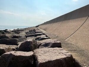 A tall concrete wall, slanted away from the gulf, goes for miles toward the West. Concrete wall on the right, Gulf on the left of the picture, all the way out to the horizon.