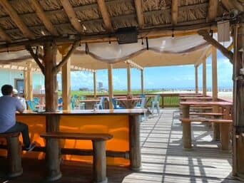 A bright orange panel catches the sunlight on an indoor/outdoor patio at Flip Flops Bar and Grill in Galveston Texas