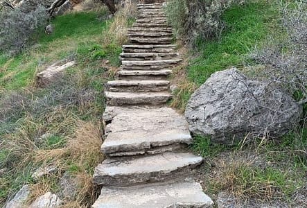 A very long flight of stairs made of rocks.