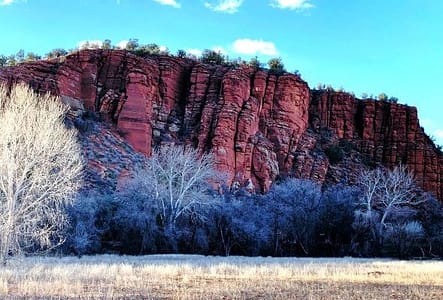 The rough, raw edge of exposed red rocks, making-up a hillside.