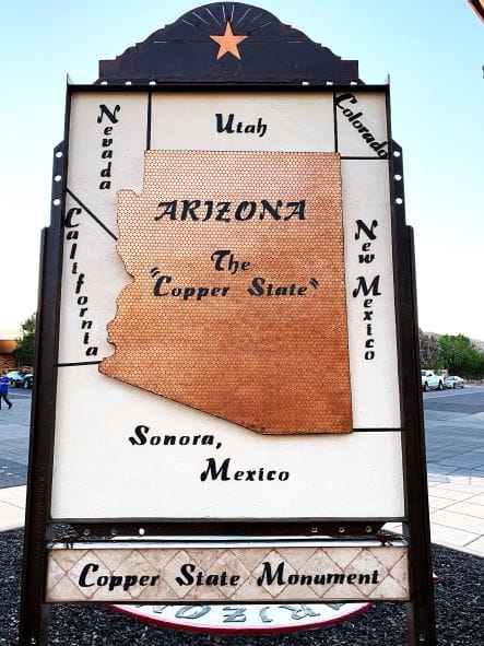This sign is in the shape of Arizona, and it's made out of copper perries, laid flat.