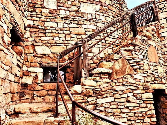 Rocks were strategically placed to create the watchtower's outer wall, and a flight of stairs. Windows are in place, as is a wood (and iron) handrail.