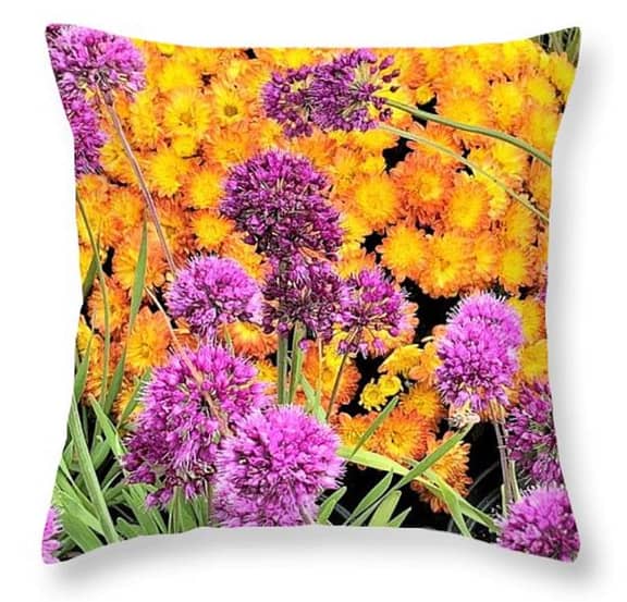 A square pillow with bright Orange flowers in the background, and purple ones in the foreground. Listed under "How to make your own throw pillows"