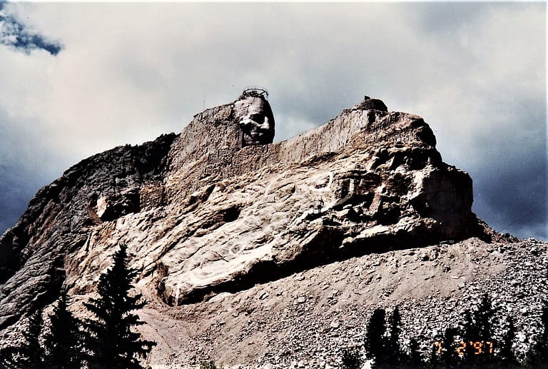 Crazy Horse Monument taken in 1997 shows the mountainside much bulkier and thicker than the 2021 photo, suggesting that they have done a lot of work since 1996
