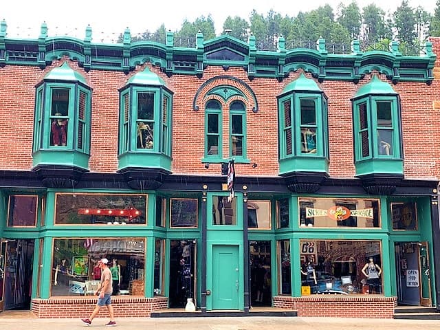 Brick Building with Seafoam Green Trim in Deadwood which is near Mount Rushmore.
