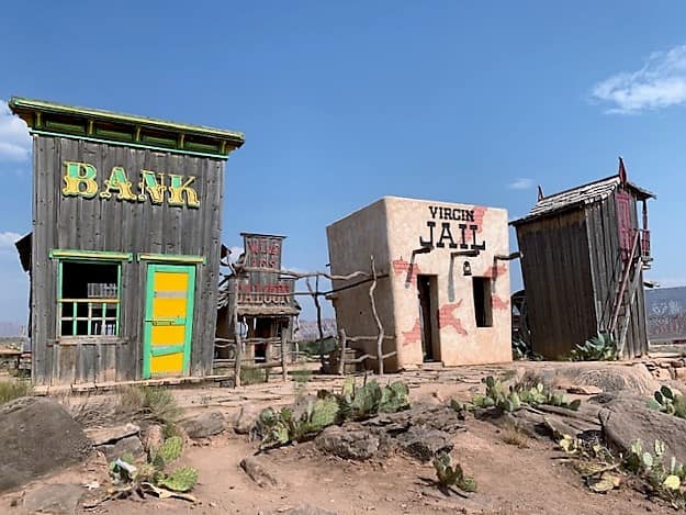 Miniature buildings inside the petting zoo. One says "Bank" and the other says "Virgin Jail". One in the background says "Wild Ass Saloon"