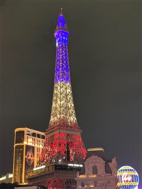 Eiffel Tower in Las Vegas at night: Red on the bottom, White lights in the middle, and blue lights on the top light up this Eiffel tower in Las Vegas.