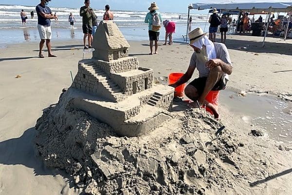 Artist at work This one was separate from the competition. One artist works on a pile of sand that is taking shape into a castle.
